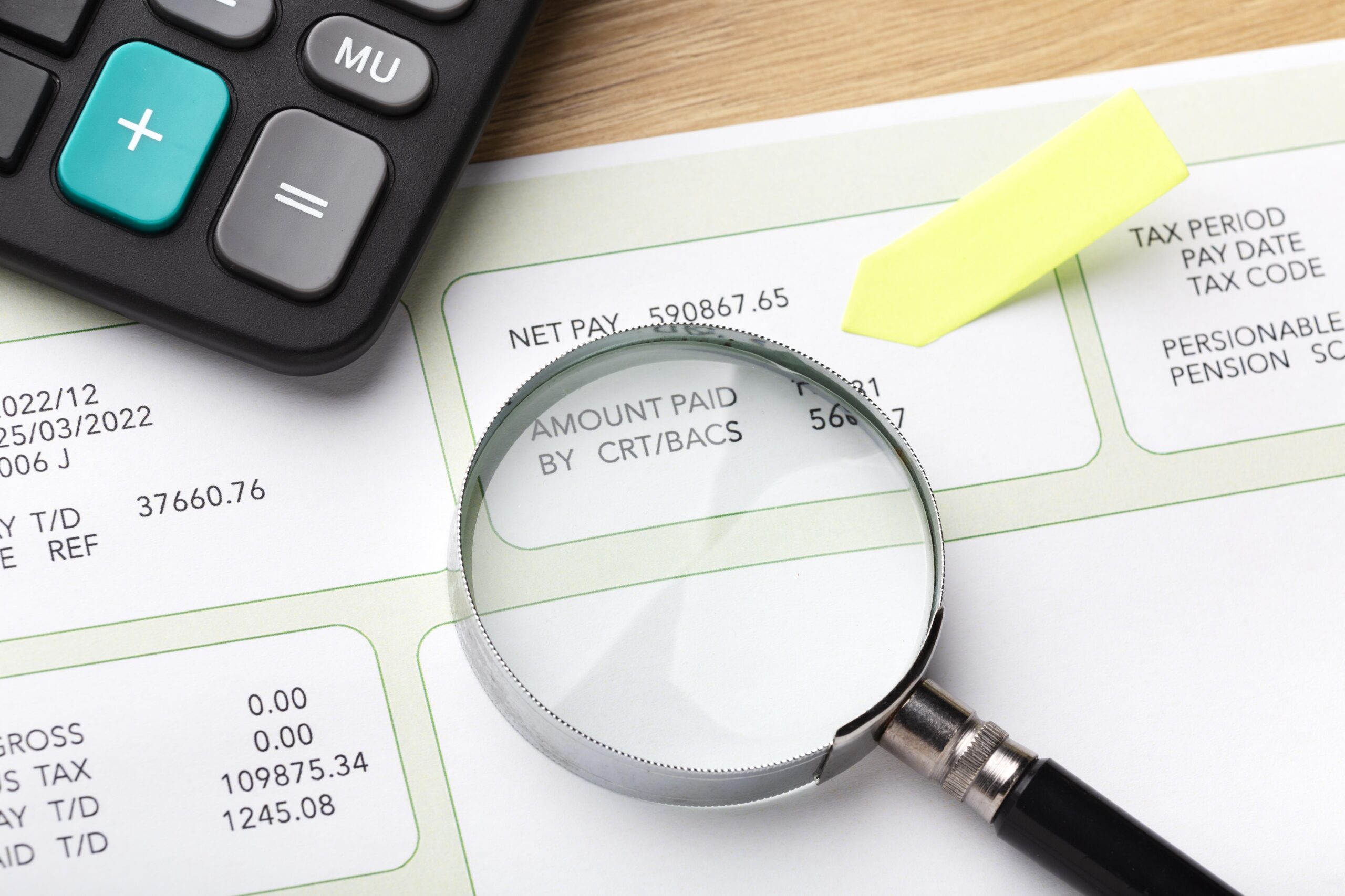 payroll-still-life-with-magnifying-glass